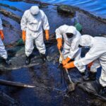 Volunteers collect leaked oil from the MV Wakashio bulk carrier that had run aground at the beach in Bois des Amourettes, Mauritius, on August 13, 2020. - Mauritius avoided a second catastrophic oil spill on August 12, 2020, after salvage crews pumped the remaining fuel from the tanks of a cargo ship that ran aground off its coast, imperilling world-famous wildlife sanctuaries. (Photo by Beekash Roopun / L'Express Maurice / AFP)